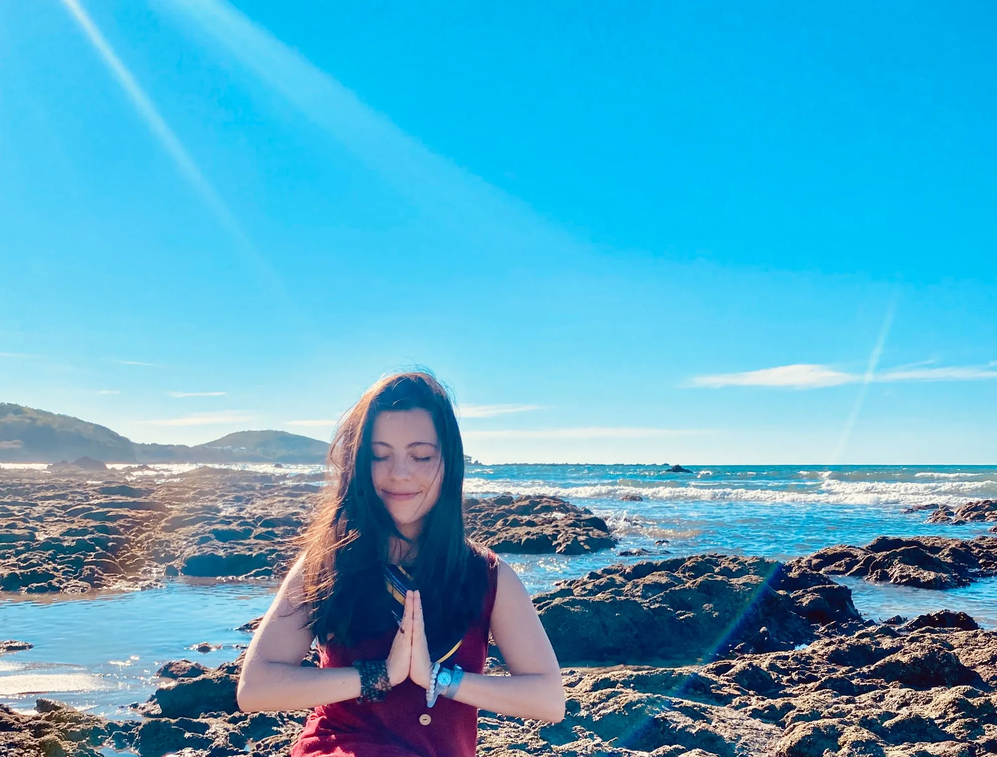 Woman in a grounding yoga pose connecting body and breath in nature
